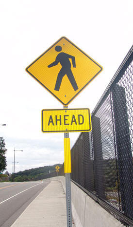 Reflective sign post panel on crossing ahead sign
